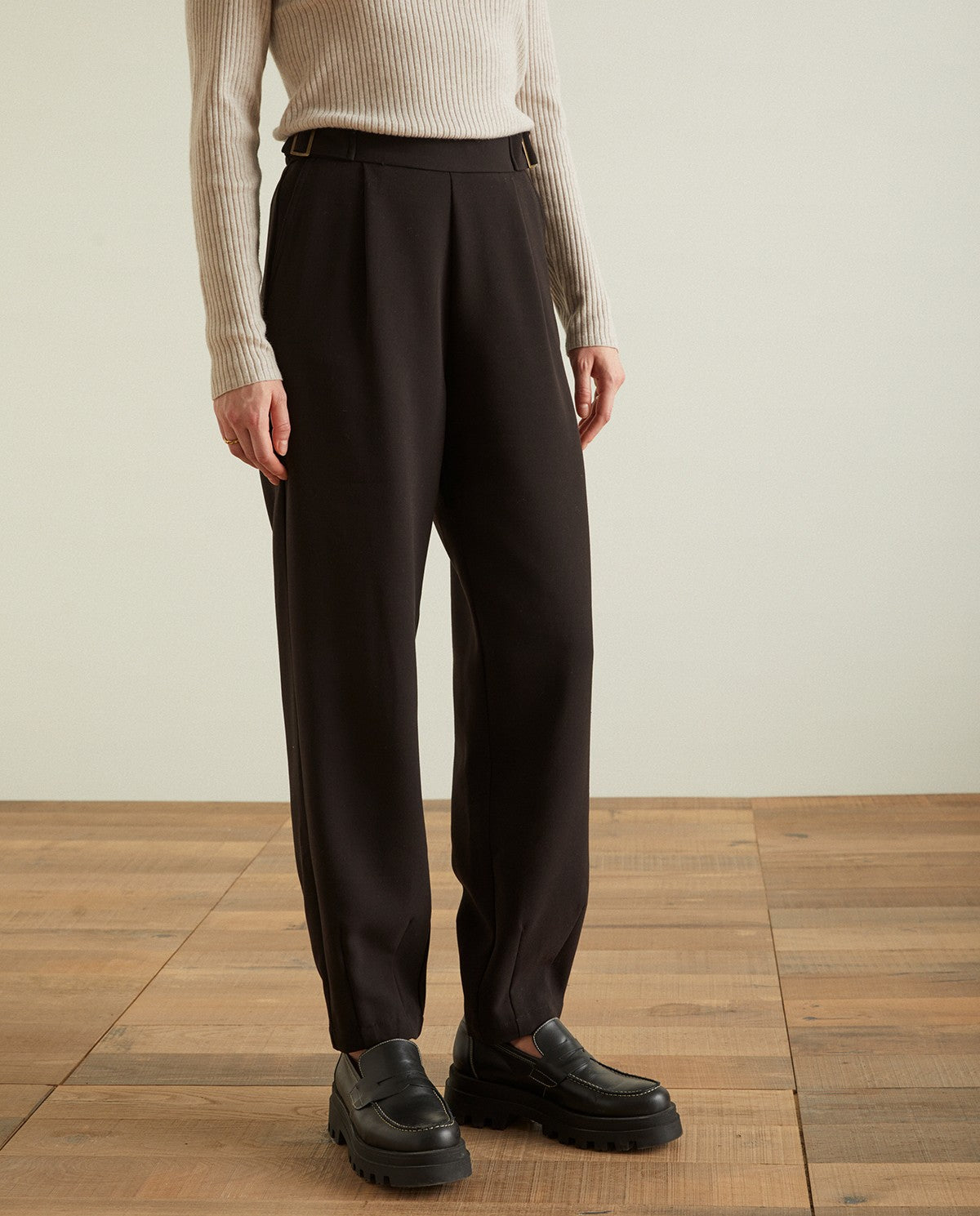 Pleated ankle trousers in black by YERSE